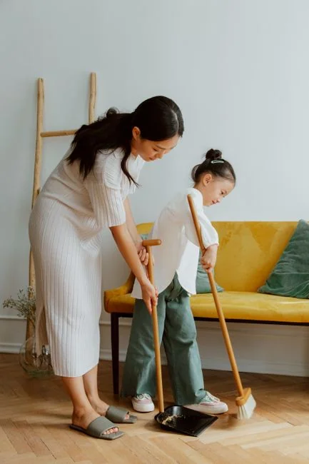 A chambermaid arranges pillows in a luxurious hotel room, showcasing comfort and elegance.
